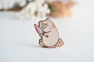 Milkie holding Knife Enamel Pin